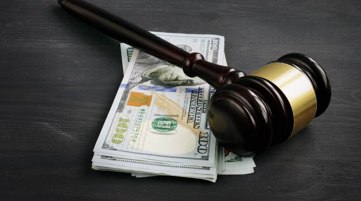 image showing a gavel and money for car accident attorney fees article
